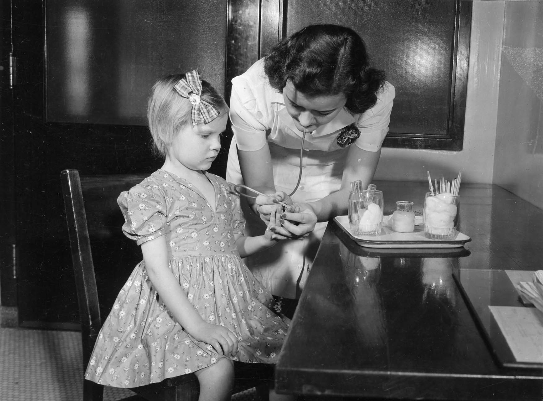 Pediatrician working with a girl in 1960s