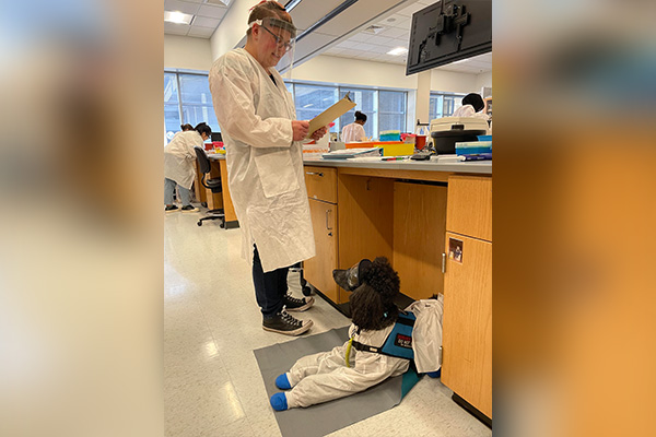 Wesley Flint in the lab with service dog, Nora