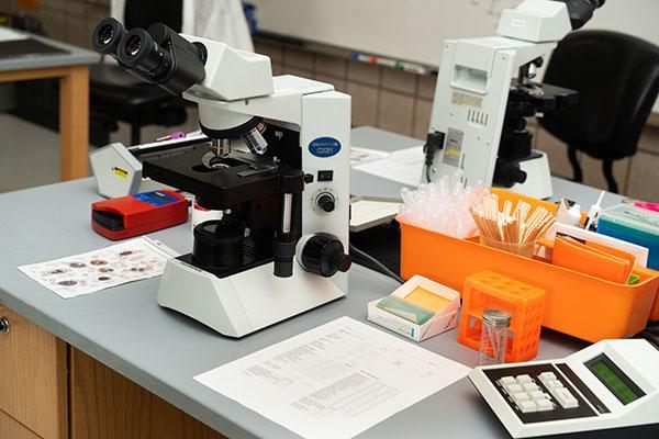 Microscope and other lab equipment sitting on a table