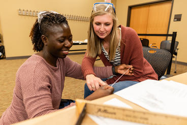 Two OT students working together in classroom